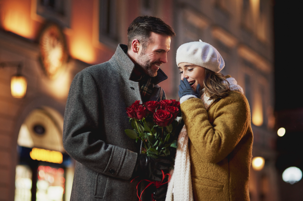 couple gifting romantic red roses