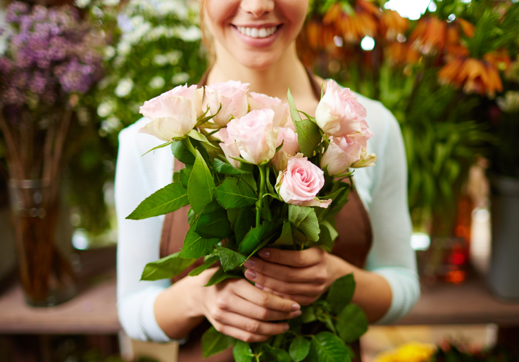 holding pink roses bouquet